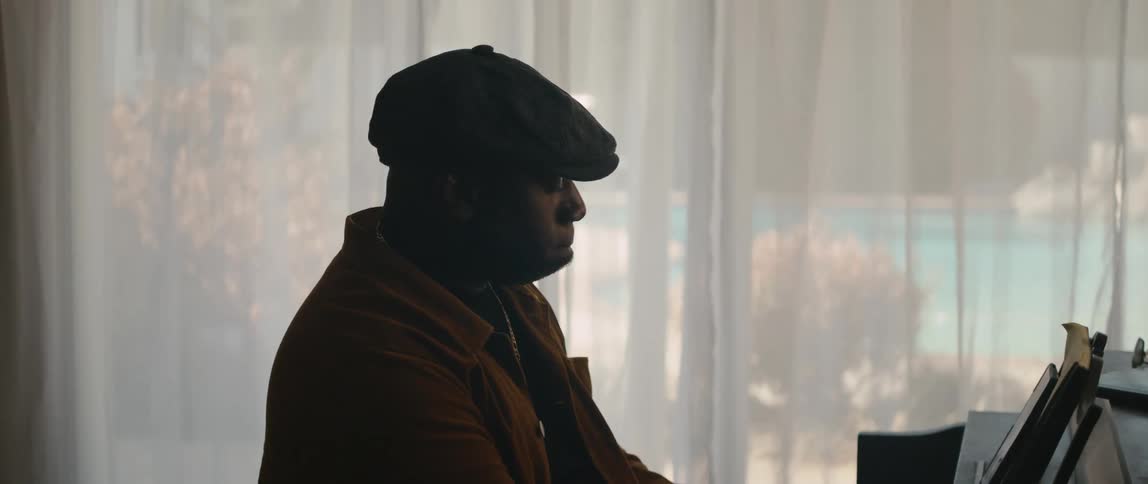 A man playing a piano in a room