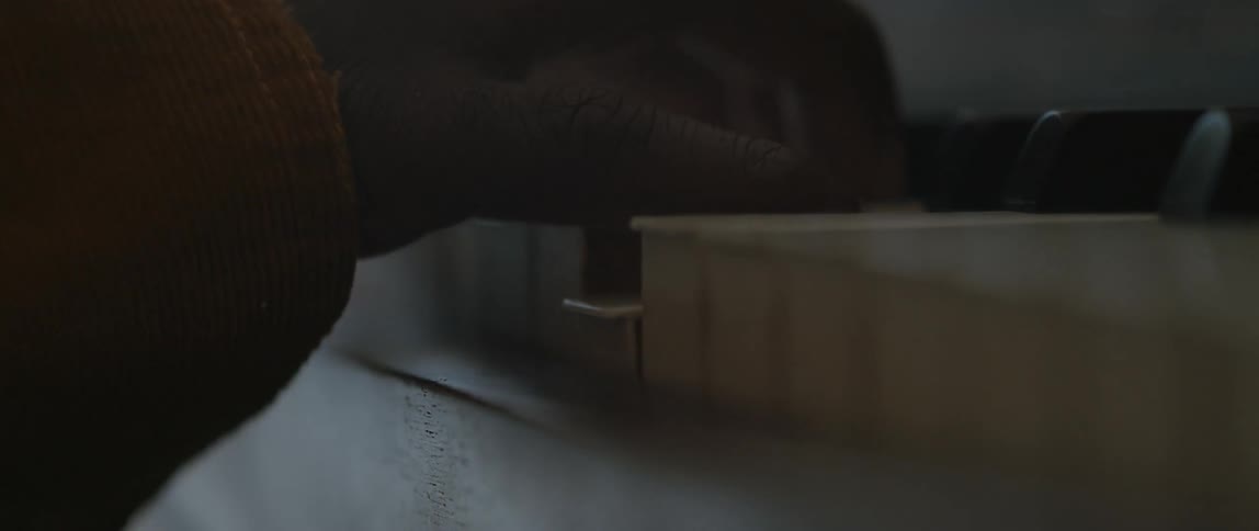 A pianist is playing a song on a piano