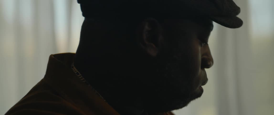 A man is in a room and nods his head