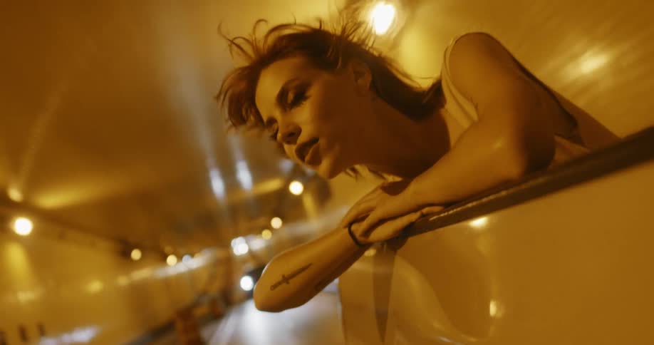 A young woman is inside the vehicle driving through a tunnel