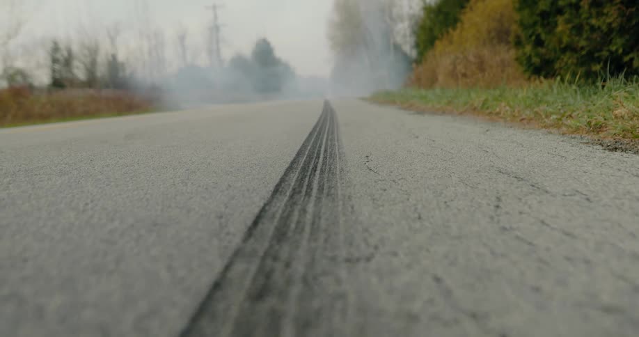 Tire marks lead to smoke in the distance