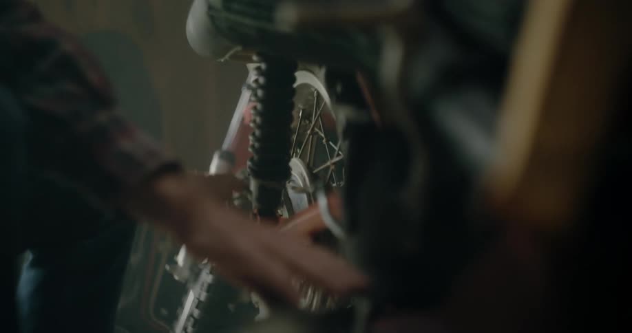 A person is fixing a wheel on a bicycle