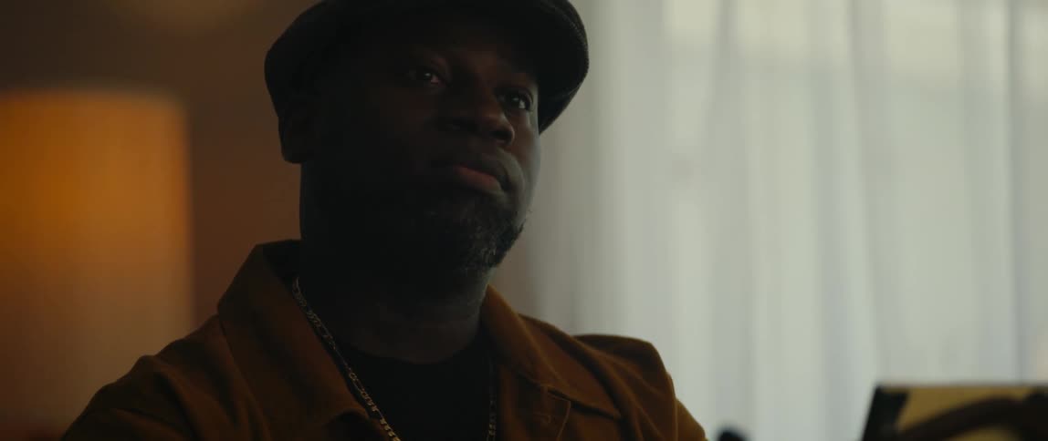A man playing the piano looks around the room