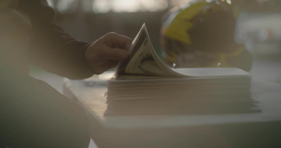 A person is flipping through pages in a booklet