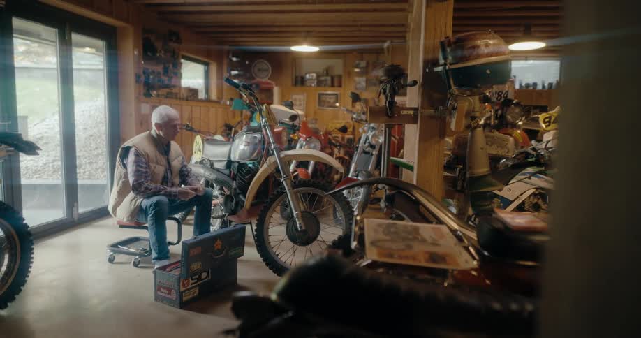 A man is working on a motorcycle in a garage