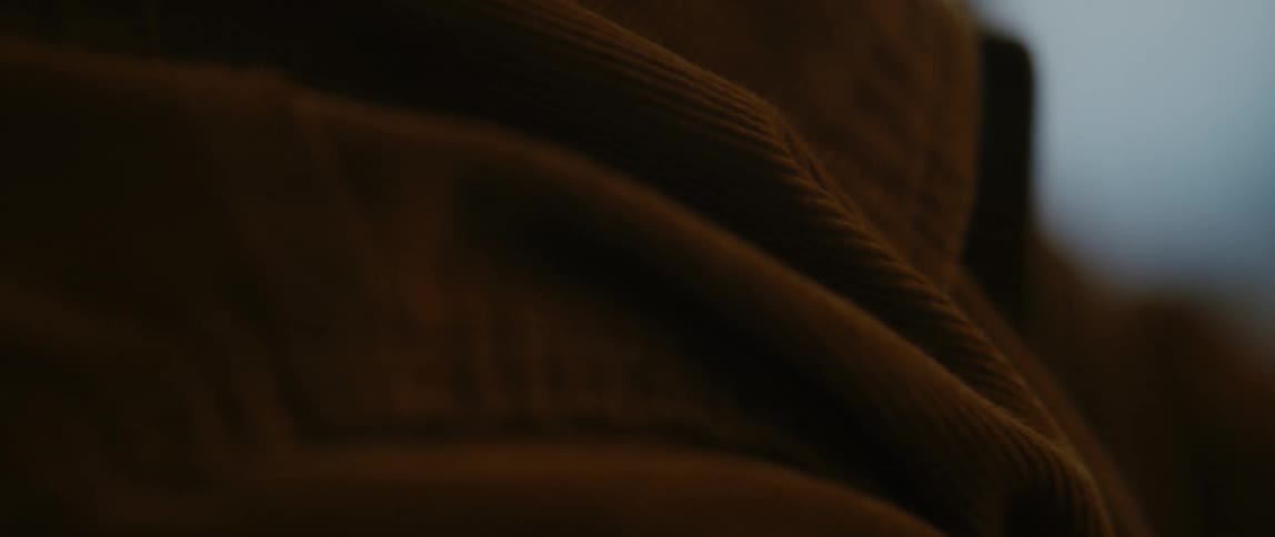 The person is wearing a brown jacket