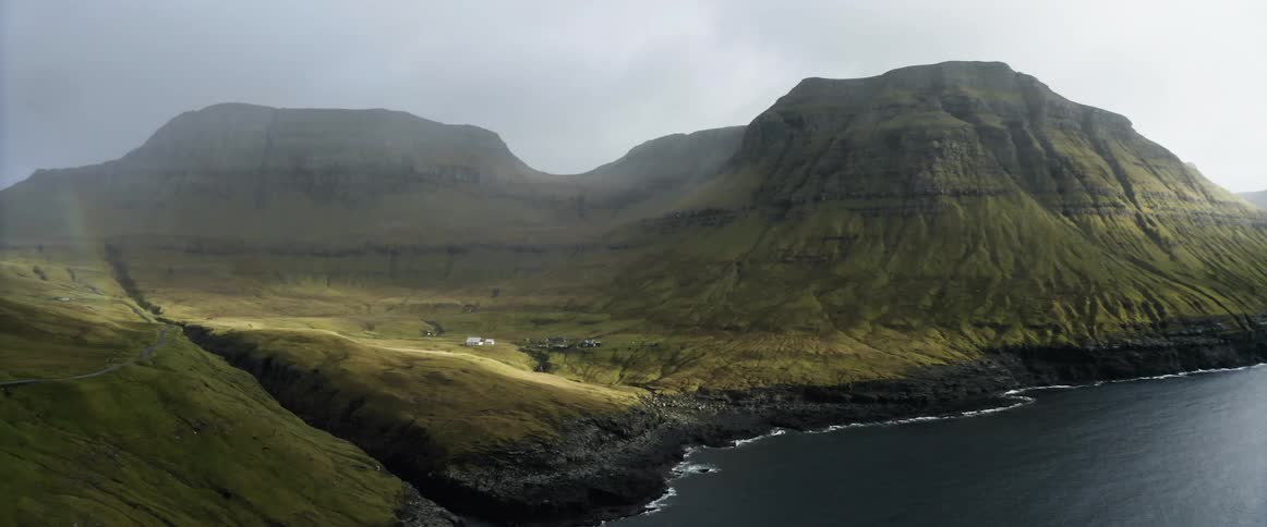 An aerial view of coastal mountains on a misty day