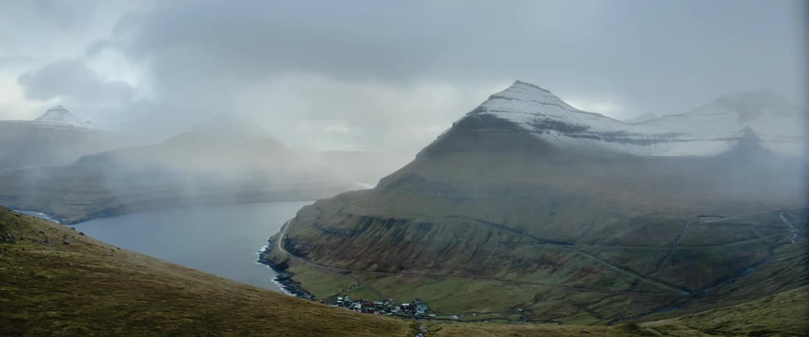 The fog is hanging over the mountain