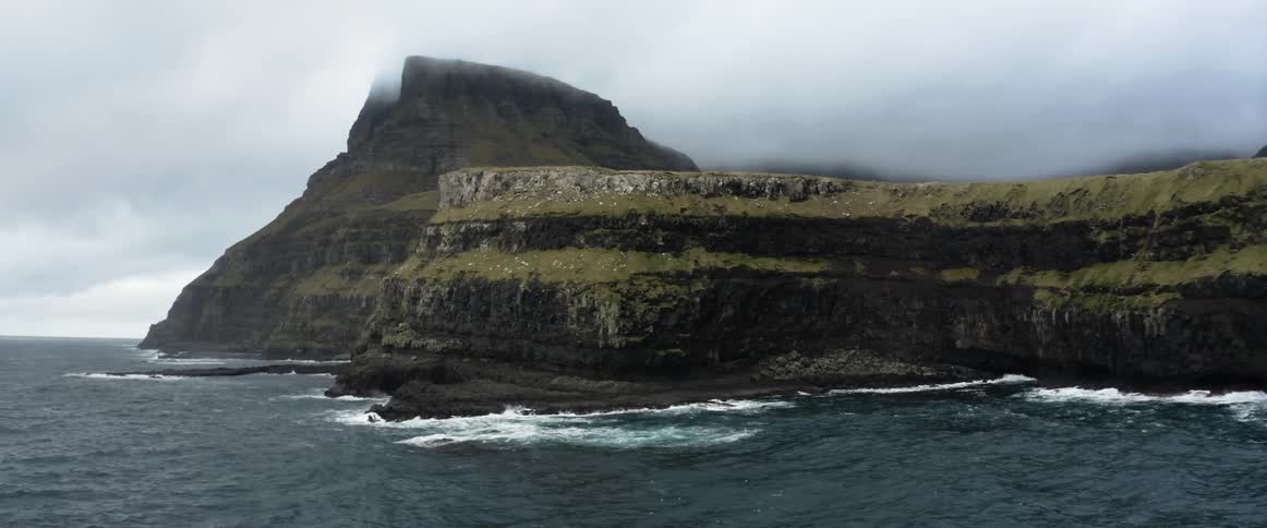 Ocean waves are moving towards the island coast