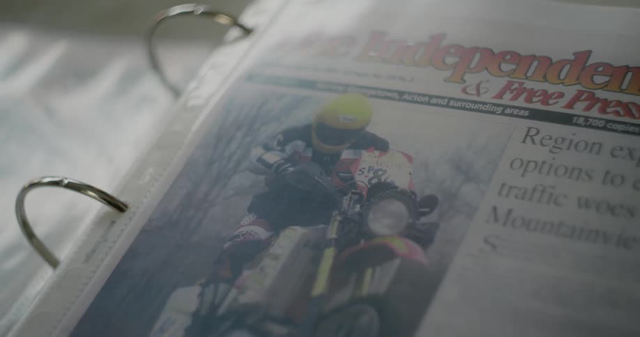 Newspaper clip inside a transparent sleeve stored on a ringed file binder