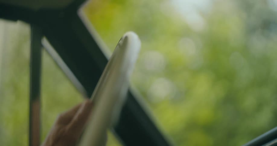 A man is turning the steering wheel as he navigates his automobile