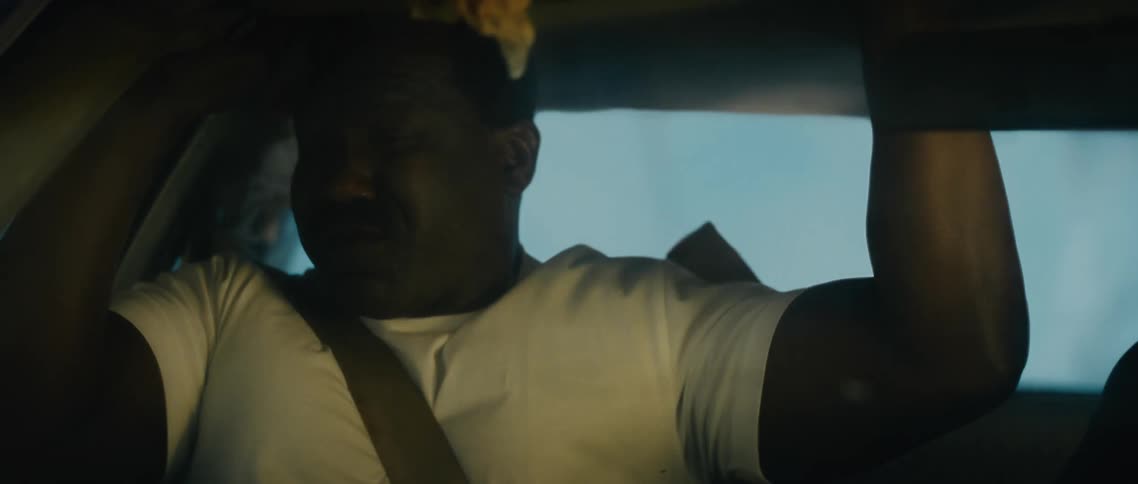 A man in an upside down vehicle during a car accident