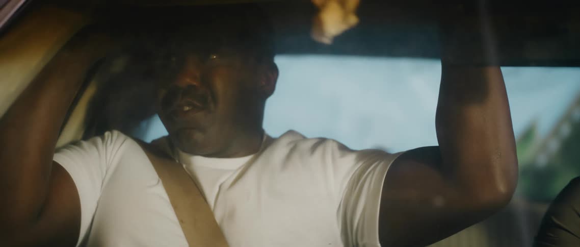 A man is a passenger in a moving car