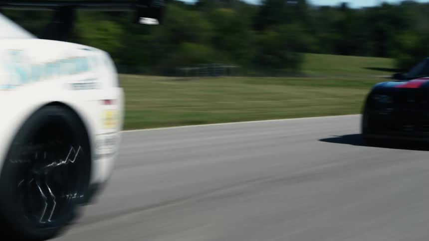 Two cars race on the lane