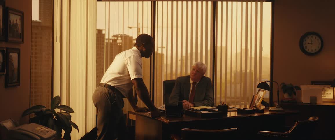 Two coworkers are talking to each other in their office