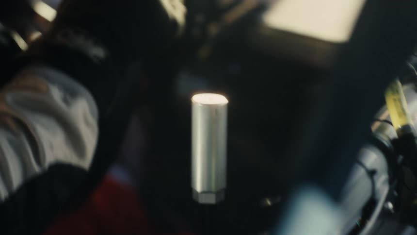 A person pulls the gear shift while racing a car