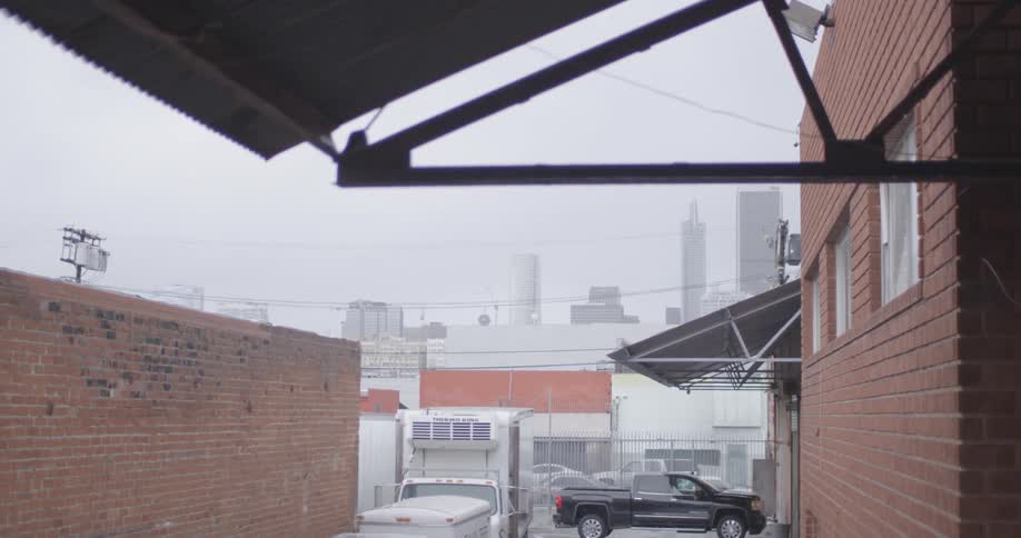 Cars are parked in this lot on a foggy day