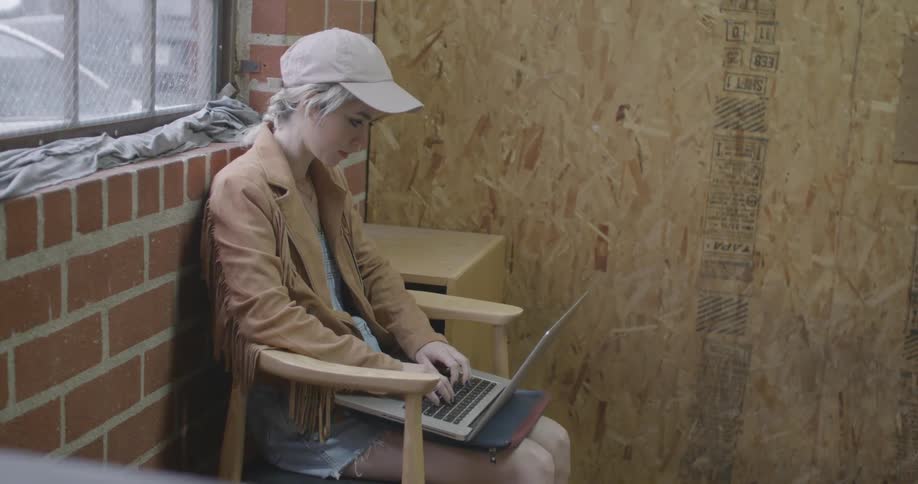 A woman typing on a laptop