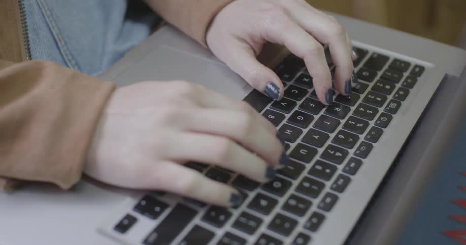 A person types on a laptop