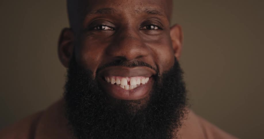 A man with a big smile on his face showing teeth