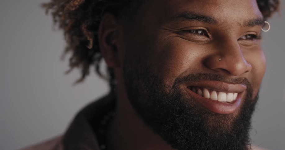 A man gives a wide smile