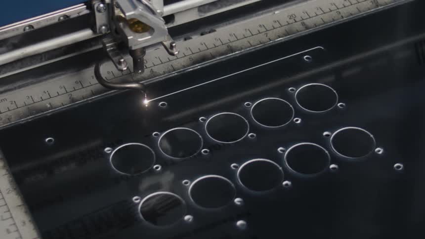 Industrial laser cutting machine cuts a straight line of plastic material