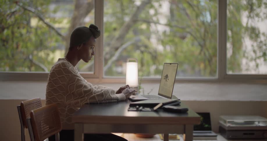 A woman sitting in front of a laptop
