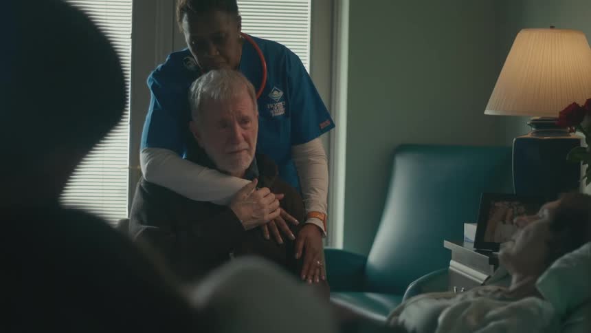 People are sad as they watch a sick person in the hospital
