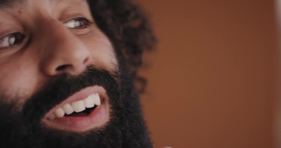 Man happy with how his beard is looking rubbing and touching it with awe