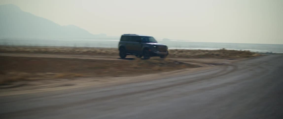 Vehicle takes a sharp curve on a road in the desert