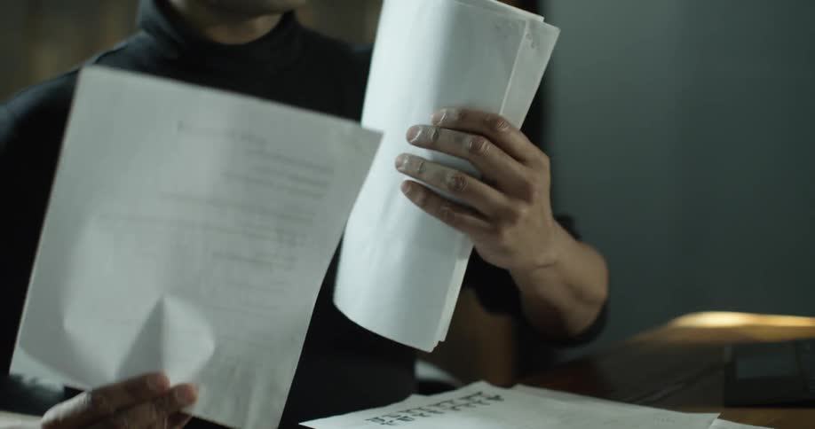 A man is sorting papers on a table