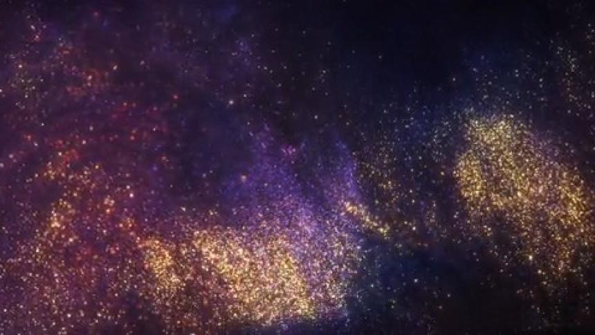 A burst of color appears as a black wave moves