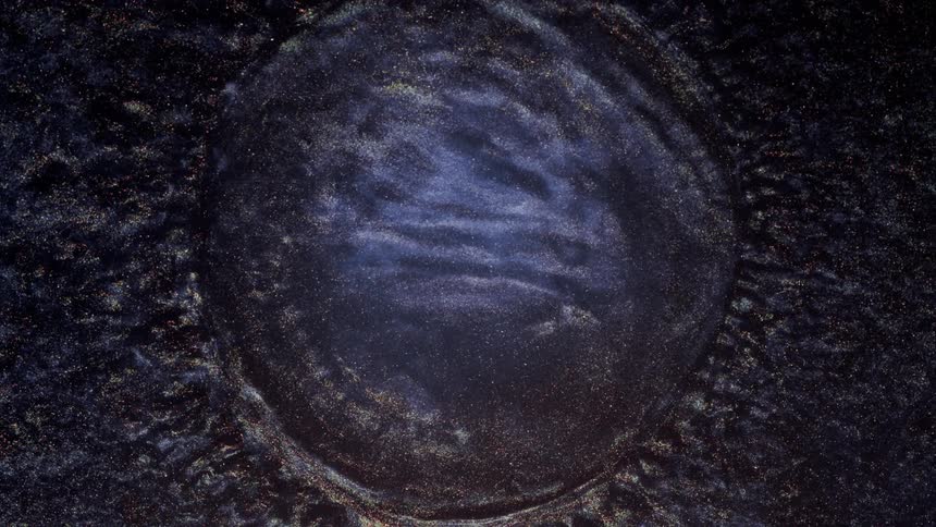A colorful liquid full of texture explodes outward then collapses on itself