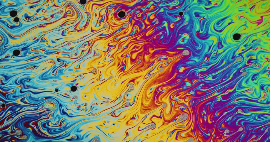 Fluorescent psychedelic colors swirl and move into areas of other colors