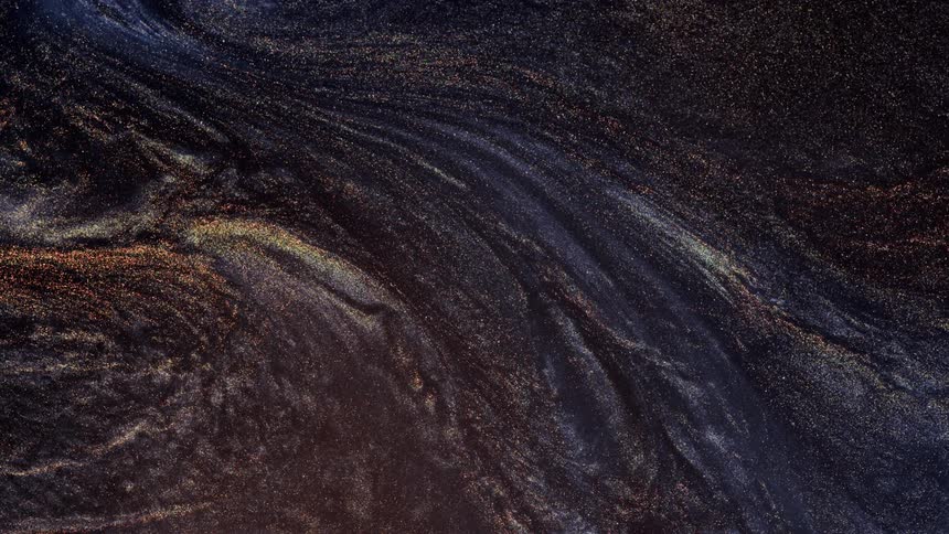 Colored bands of stars move across the darkness as if they were alive