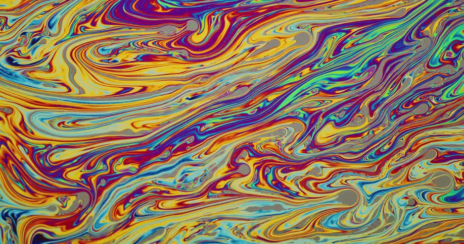 Chaotic psychedelic multicolored bright liquid ink swirling