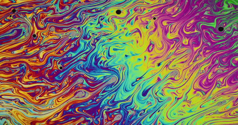 Brightly colored multi hued swirls flow and blend