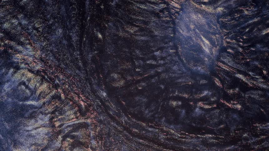Dark glittering blue and black liquid ink flowing in concentric waves