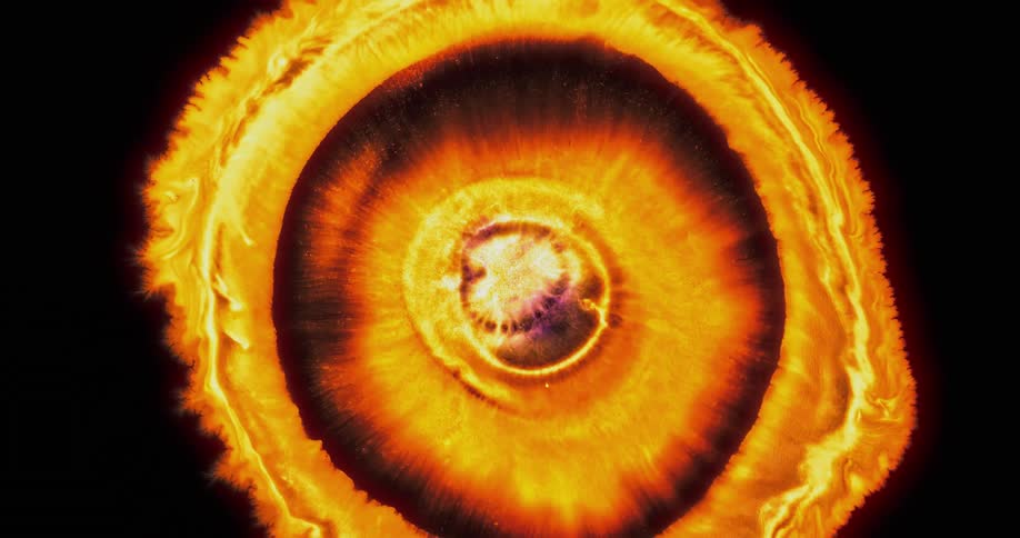 A round explosion of orange and yellow splashing out and expanding on black