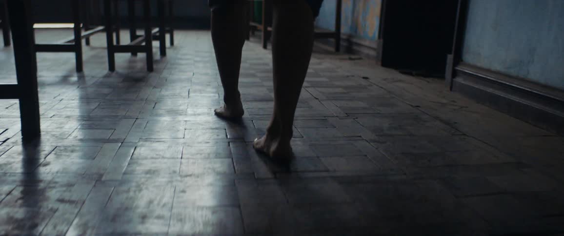 A person walks through the dark room
