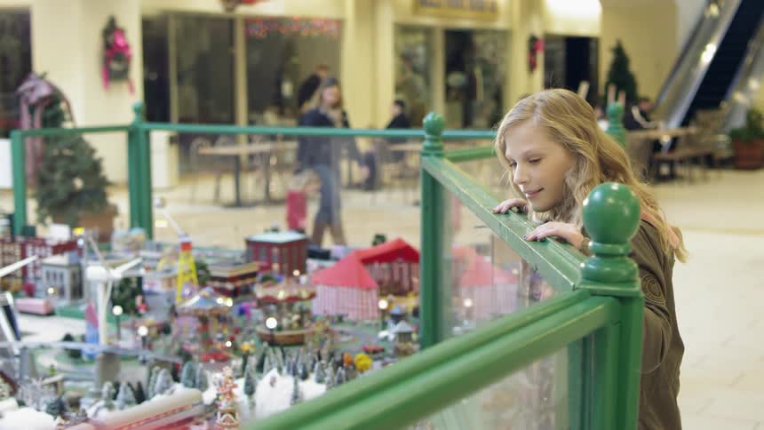 A woman is looking a mall display with miniatures