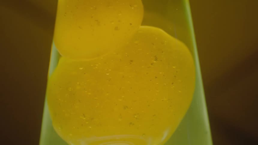 Substance moves up through the oil in a lava lamp