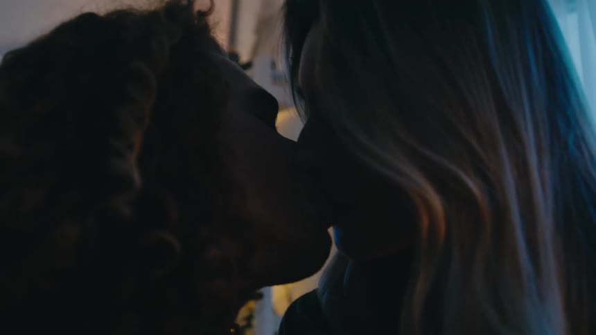 Boyfriend and girlfriend are kissing in an indoor room