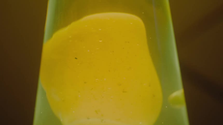 Close up view of a lava lamp is displayed in a room