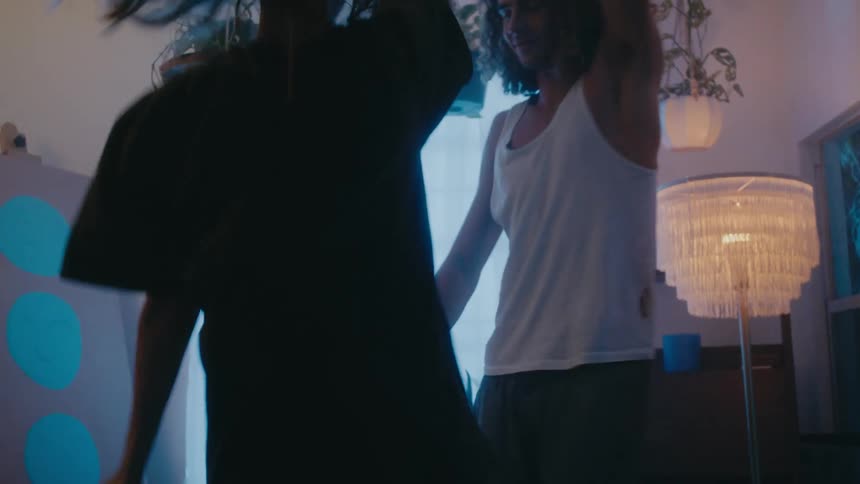 Boyfriend and girlfriend are dancing in their home together
