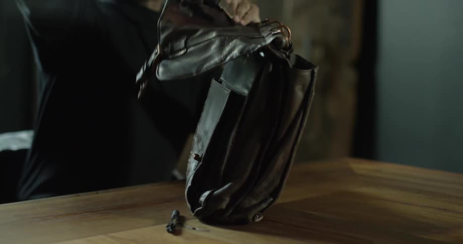 A man opens is bag and puts away his belongings