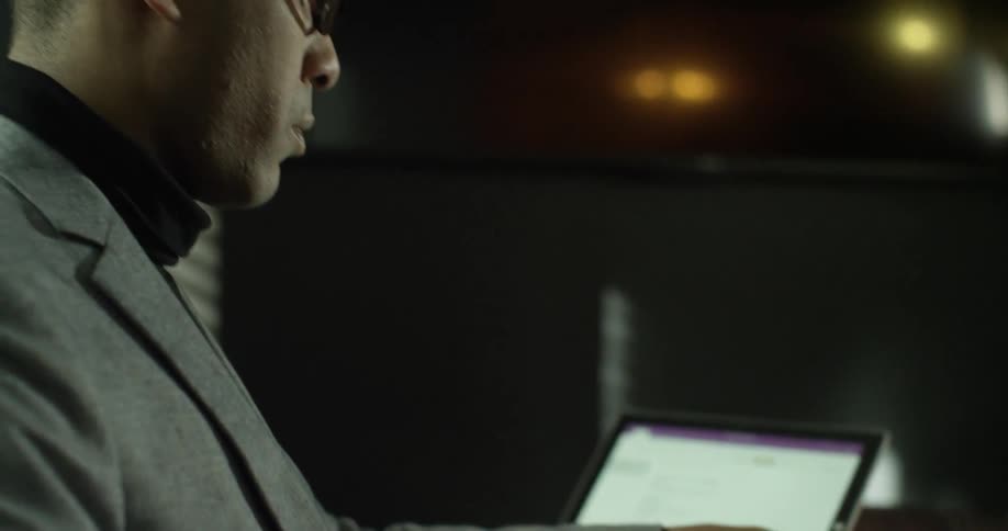 A man is sitting at a table writing