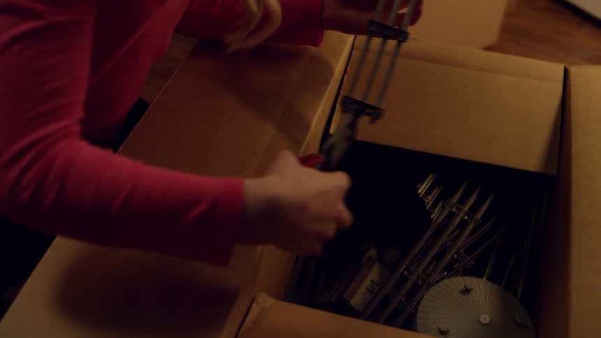 Young girl opens box that contains a model train track