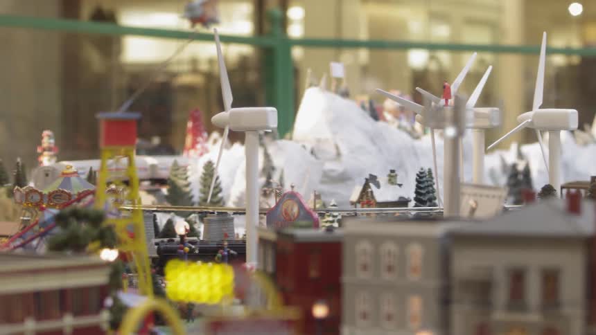 A toy train travelling through a toy village