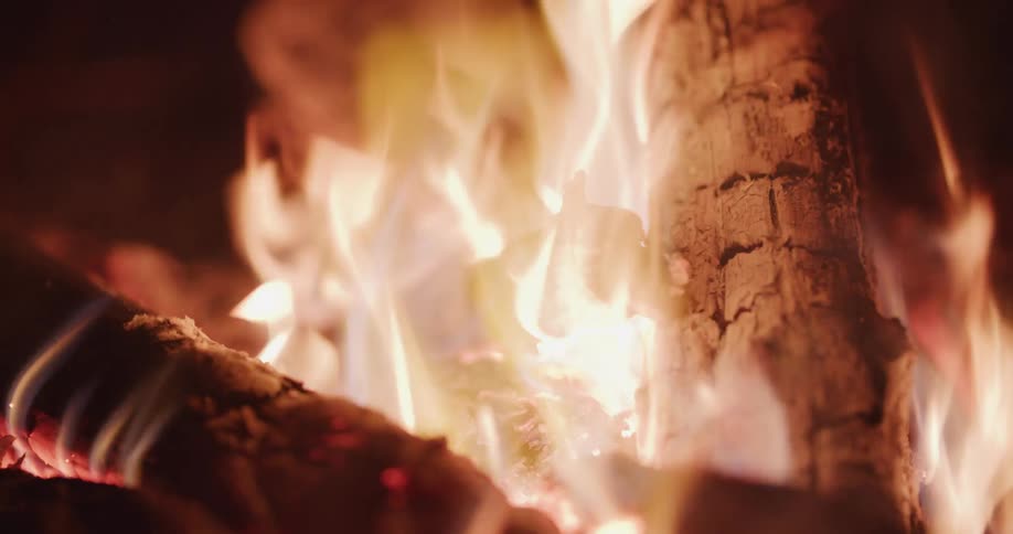 Flames flickering around pieces of firewood